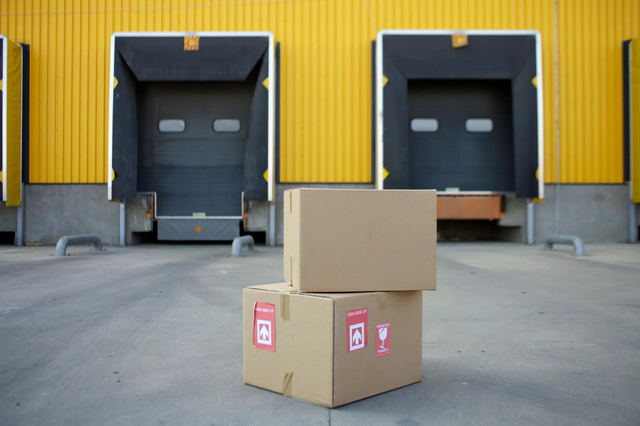 Cardboard cartons standing in front of warehouse loading docks